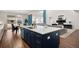 Open-concept kitchen with a large center island, modern appliances, and seamless flow to the living area at 5861 Tesoro Pt, Parker, CO 80134
