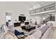 Expansive living room with soaring ceilings, fireplace, and comfortable seating with modern finishes at 5861 Tesoro Pt, Parker, CO 80134