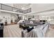Bright living room with high ceilings, modern staircase, and an open-concept kitchen and dining area at 5861 Tesoro Pt, Parker, CO 80134