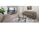 Inviting upstairs living room with comfortable seating, an oval glass coffee table, and a view of the staircase at 5861 Tesoro Pt, Parker, CO 80134