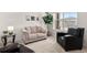 Cozy living room features neutral colors, a comfortable couch and chair, and a view from the window at 5861 Tesoro Pt, Parker, CO 80134