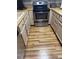 Cozy kitchen featuring wood-look floors, neutral cabinets and a stainless-steel stove at 16941 E Chenango Ave # C, Aurora, CO 80015