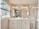 Modern bathroom features double sinks, a large mirror, and tiled shower at 5435 W 97Th Pl, Broomfield, CO 80020