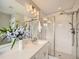 Bright bathroom features modern sink and tiled shower with glass door at 5435 W 97Th Pl, Broomfield, CO 80020