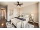 Cozy bedroom with a sitting bench, ceiling fan and ensuite bath at 5435 W 97Th Pl, Broomfield, CO 80020