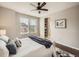 Bright bedroom features a ceiling fan, large window, and ensuite bathroom at 5435 W 97Th Pl, Broomfield, CO 80020