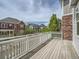Spacious wooden deck with white railing and neighborhood views at 5435 W 97Th Pl, Broomfield, CO 80020