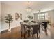 This open dining room features a glass table with seating for six and a modern chandelier at 5435 W 97Th Pl, Broomfield, CO 80020