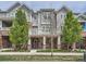 Charming two-story townhome with a covered entryway and beautifully landscaped front yard, offering curb appeal at 5435 W 97Th Pl, Broomfield, CO 80020