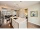 Open-concept kitchen with a large island, stainless steel appliances, and a view of the dining and living areas at 5435 W 97Th Pl, Broomfield, CO 80020