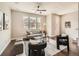Bright living room with a comfortable gray sofa, stylish accents, and a ceiling fan at 5435 W 97Th Pl, Broomfield, CO 80020