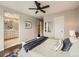 Cozy bedroom featuring a ceiling fan, plush bedding, and an ensuite bathroom at 5435 W 97Th Pl, Broomfield, CO 80020
