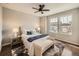 Bright bedroom with large windows, hardwood floors, plush bed, and comfortable seating at 5435 W 97Th Pl, Broomfield, CO 80020