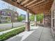 Spacious covered porch with brick columns, offering a comfortable and inviting outdoor space to relax at 5435 W 97Th Pl, Broomfield, CO 80020