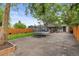 Expansive backyard features mature trees, a trampoline, and a patio area for outdoor living at 2967 Olive St, Denver, CO 80207