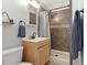 Bathroom with a tiled shower, a light wood vanity, and a modern sink, providing a clean and functional space at 2967 Olive St, Denver, CO 80207