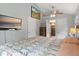 Spacious bedroom with a large bed, TV, and windows, offering a comfortable and inviting space at 2967 Olive St, Denver, CO 80207
