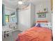Bright bedroom with a comfortable bed, decor shelf, and a window that lets in natural light at 2967 Olive St, Denver, CO 80207