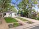 Inviting home exterior features a well-manicured lawn, mature trees, and an extended driveway at 2967 Olive St, Denver, CO 80207