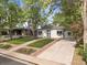 Charming home with well-manicured front yard, mature trees, and a welcoming facade at 2967 Olive St, Denver, CO 80207