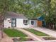 Charming single-story home with mature trees, a well-manicured lawn, and an inviting front entrance at 2967 Olive St, Denver, CO 80207