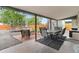 Covered patio area features outdoor furniture and a spacious setting for entertaining and backyard enjoyment at 2967 Olive St, Denver, CO 80207