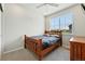 Simple bedroom with a cozy wooden bed and natural light at 6988 Ipswich Ct, Castle Pines, CO 80108
