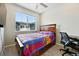 Comfortable bedroom features a wooden bed frame, a window, and carpeted floors at 6988 Ipswich Ct, Castle Pines, CO 80108