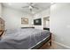 Bedroom with a ceiling fan, wooden furniture, large window, and ensuite bathroom at 6988 Ipswich Ct, Castle Pines, CO 80108