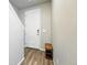 Bright entryway with wood floors, white walls, a bench, and a staircase at 6988 Ipswich Ct, Castle Pines, CO 80108