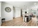 Open floor plan shows kitchen with island connecting to the living room at 6988 Ipswich Ct, Castle Pines, CO 80108