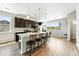 Bright kitchen features a large central island, dark cabinetry, and plenty of natural light at 6988 Ipswich Ct, Castle Pines, CO 80108