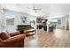 Open-concept living room featuring hardwood floors, neutral walls, and a ceiling fan at 6988 Ipswich Ct, Castle Pines, CO 80108