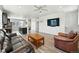 Spacious living room with wood floors, an island with barstools, and lots of natural light at 6988 Ipswich Ct, Castle Pines, CO 80108