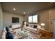 Inviting living room featuring modern decor, hardwood floors, and large window at 1705 S Yuma St, Denver, CO 80223