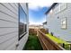 Narrow backyard between two homes with artificial turf and a wood fence at 8358 Howell St # B, Arvada, CO 80005
