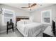 Cozy bedroom with neutral tones, a ceiling fan, and natural light from two windows at 8358 Howell St # B, Arvada, CO 80005