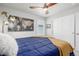 A bedroom featuring a ceiling fan, window, and a decorative world map on the wall at 8358 Howell St # B, Arvada, CO 80005