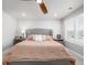 Comfortable primary bedroom featuring a tufted headboard, neutral color palette, and sitting area at 8358 Howell St # B, Arvada, CO 80005