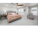 Comfortable primary bedroom featuring a tufted headboard, neutral color palette, and sitting area at 8358 Howell St # B, Arvada, CO 80005