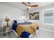 Neutral bedroom featuring a ceiling fan, window, and a world map on the wall at 8358 Howell St # B, Arvada, CO 80005