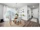 Bright dining area with a modern table, stylish chairs, and sliding glass doors at 8358 Howell St # B, Arvada, CO 80005