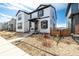 Beautiful two-story home boasts white siding, black trim, well-kept landscaping, and inviting curb appeal at 8358 Howell St # B, Arvada, CO 80005