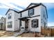 Charming two-story home with white siding, black trim, well-kept landscaping, and welcoming front porch at 8358 Howell St # B, Arvada, CO 80005