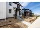 Beautiful home with white siding, black trim, a well-kept yard, and a charming entrance, great curb appeal at 8358 Howell St # B, Arvada, CO 80005