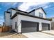 Home exterior with two-car garage, modern siding, and rock landscaping at 8358 Howell St # B, Arvada, CO 80005