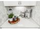 Quartz kitchen counter with modern coffee making appliances and decorative items on eye catching geometric backsplash at 8358 Howell St # B, Arvada, CO 80005