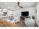 An open living space boasts wood floors and access to a bright, modern kitchen at 8358 Howell St # B, Arvada, CO 80005
