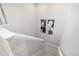 Clean stairwell with carpeted steps and minimalist wall art, leading to upper or lower levels at 8358 Howell St # B, Arvada, CO 80005