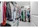 A filled walk-in closet provides ample storage space for clothing, shoes, and accessories at 8358 Howell St # B, Arvada, CO 80005